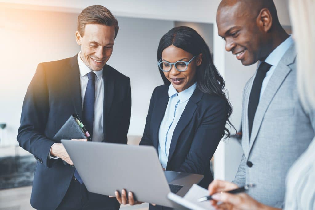 BUSINESS PEOPLE TALKING WITH COMPUTER STOCK IMAGE